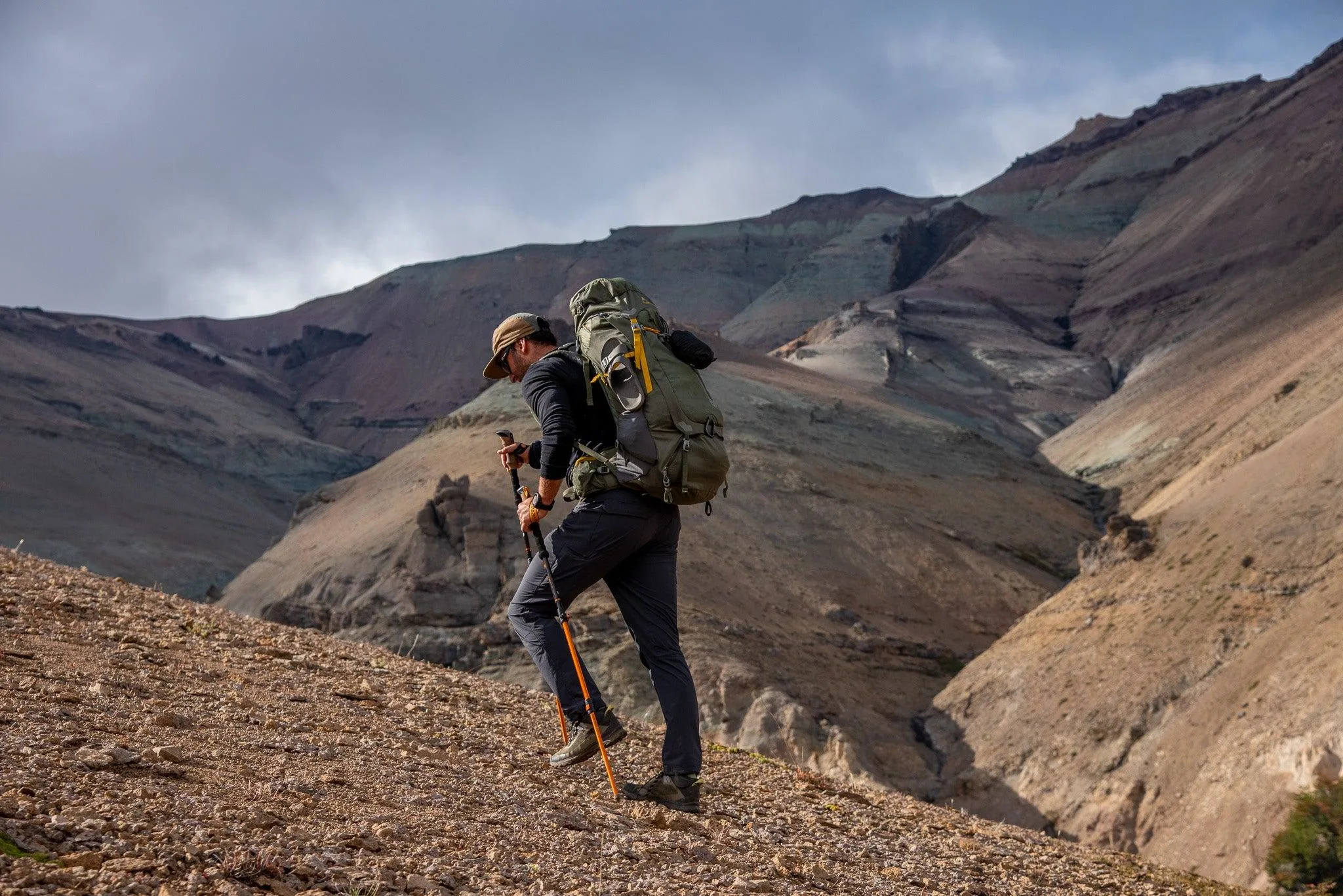 image of Trekker using trekking poles while climbing a mountain trail